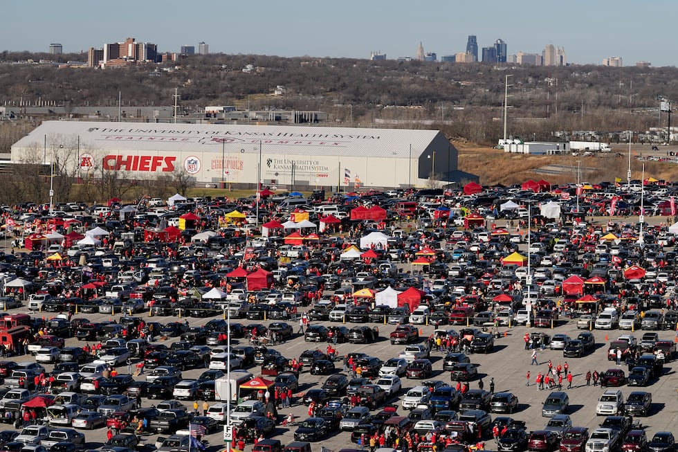 Fans tailgate in the parking lot outside Arrowhead Stadium before the start of an NFL football...