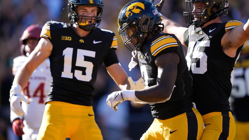 Iowa running back Kaleb Johnson (2) celebrates with teammates Reece Vander Zee (15) and Luke...